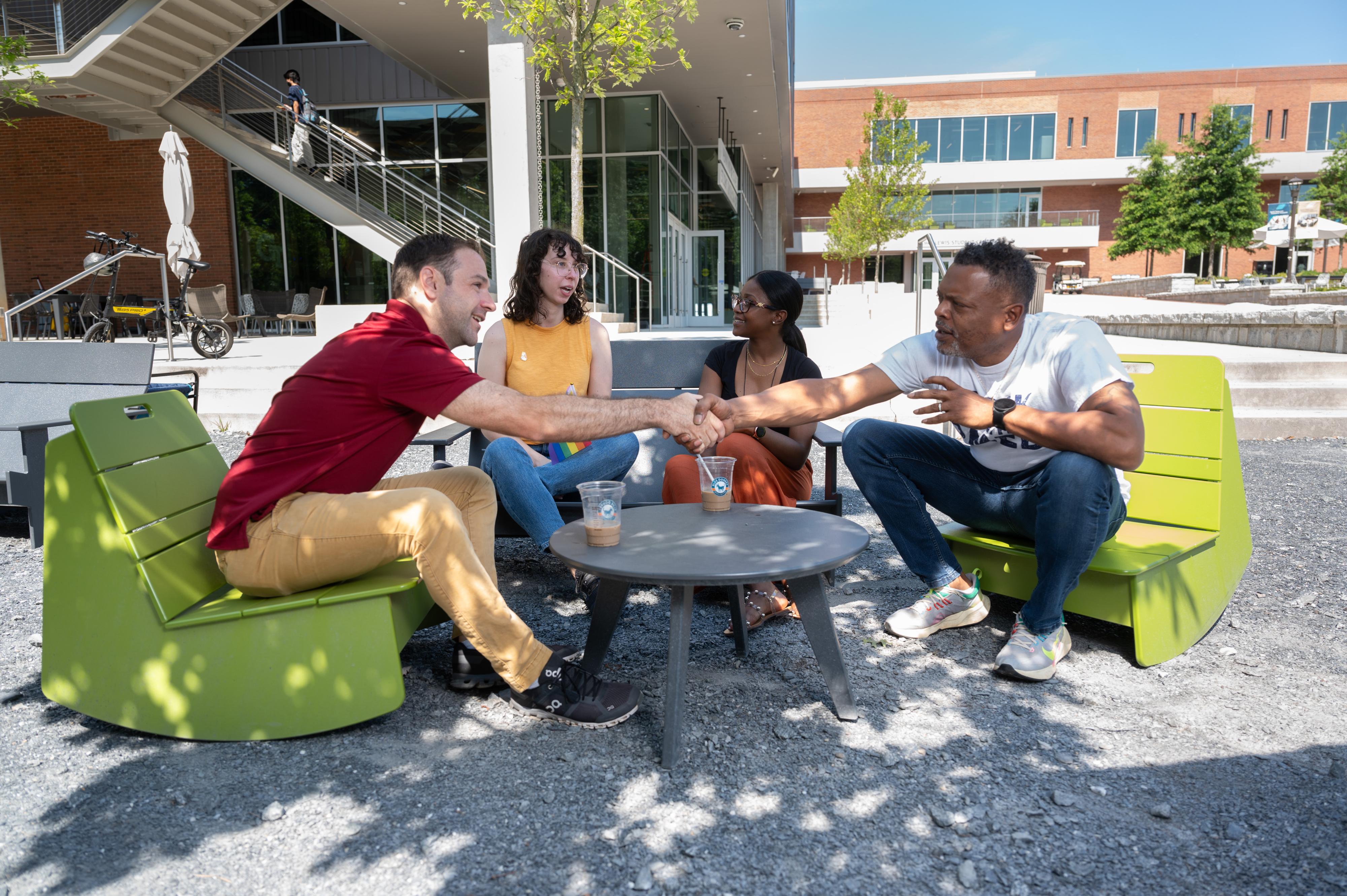 Staff talking at a table 